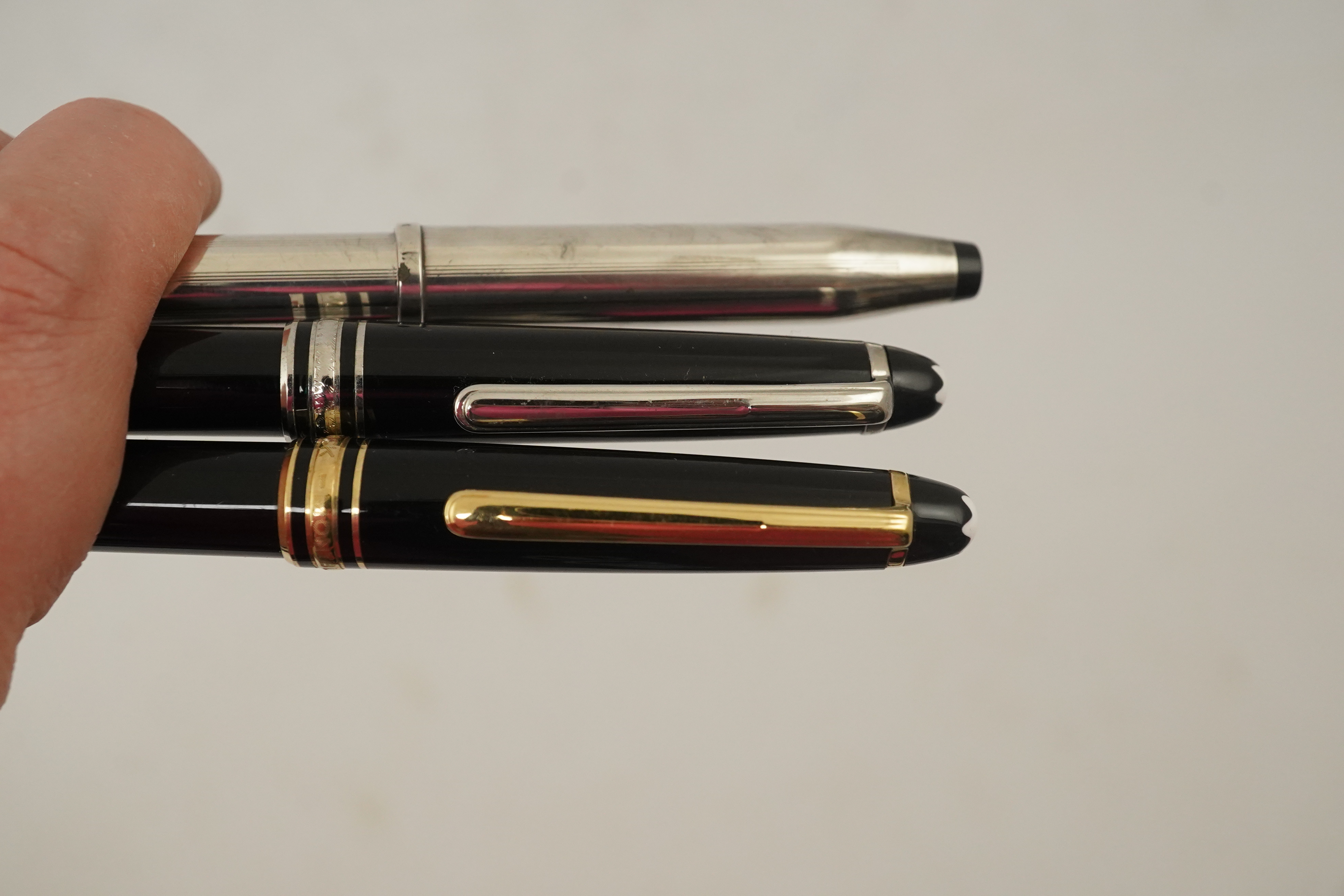 A Montblanc ballpoint pen, a Montblanc pencil and a Cross fountain pen